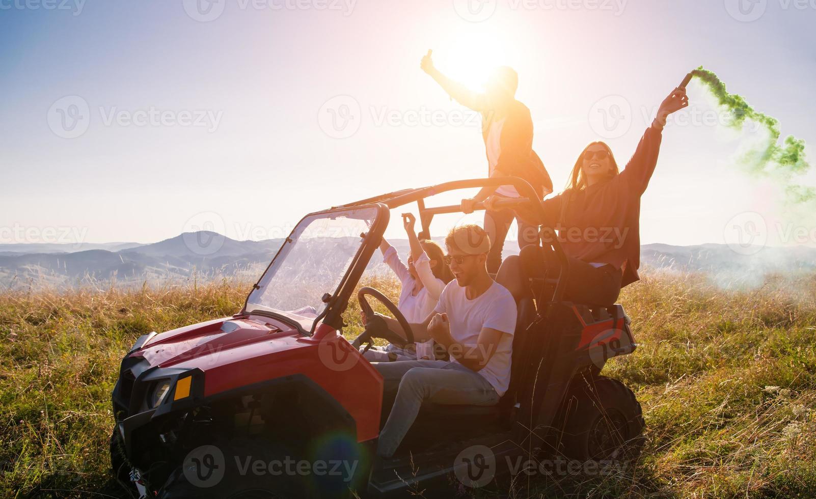 group of young people having fun while driving a off road buggy car photo