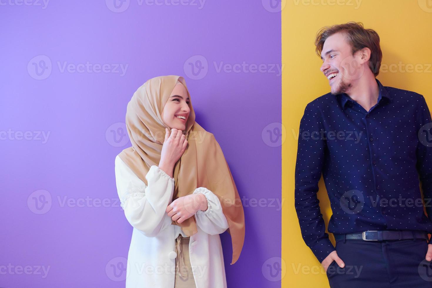 portrait of young muslim couple isolated on colorful background photo