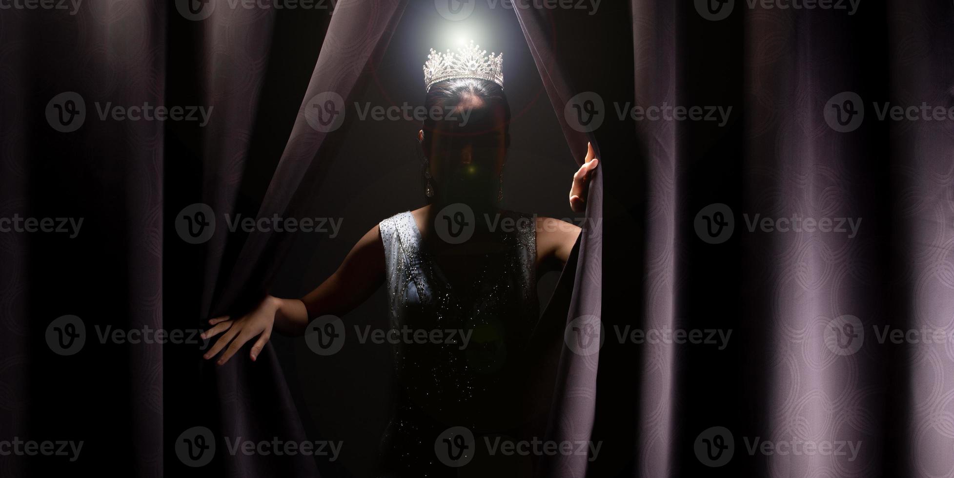 Miss Pageant Beauty Contest wears sequin Evening Gown long dress with sparkle Diamond Crown, Asian Woman opens purple Curtain after win Final round as new way life, opportunity, change, isolated photo