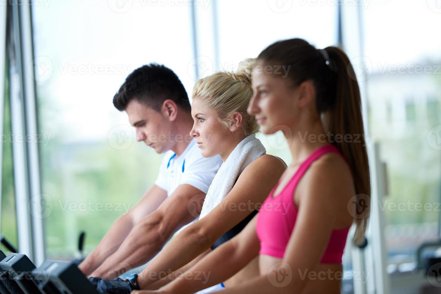 friends  exercising on a treadmill at the bright modern gym photo
