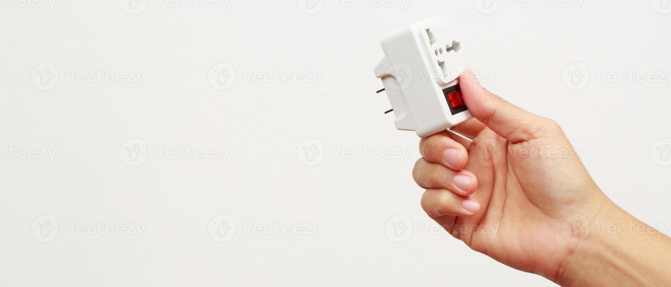 An extension socket is a device that consists of several components, such as a power cord, an electrical socket, an outlet, a power strip, and an electrical switch. photo