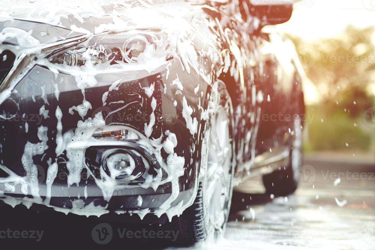 people man holding hand pink sponge for washing car. Concept car wash clean. photo