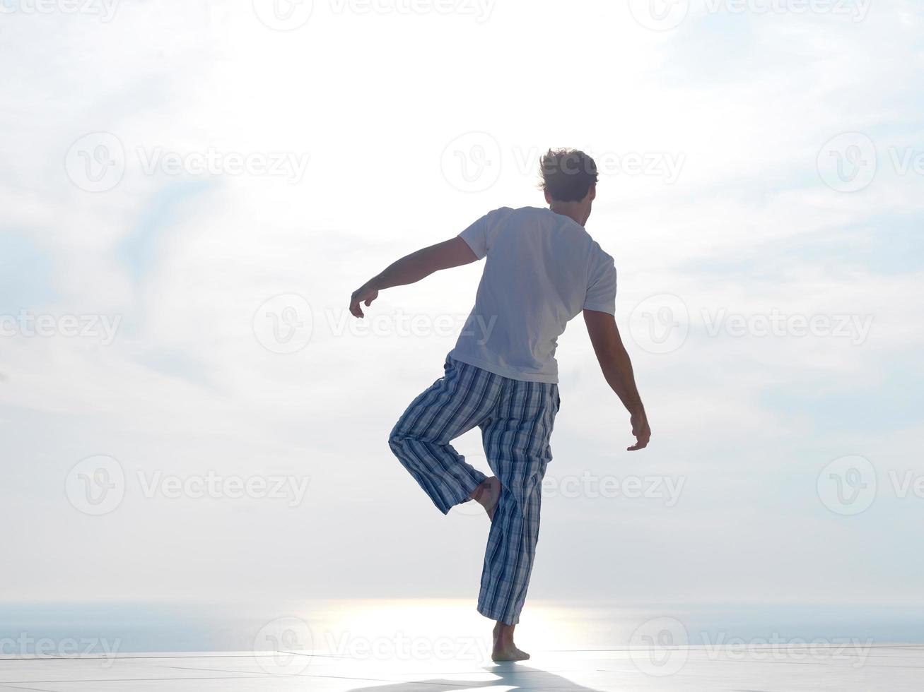 young man practicing yoga photo