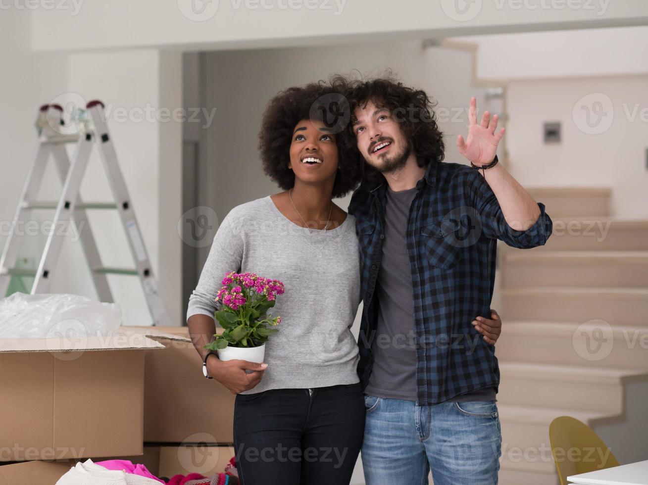 multiethnic couple moving into a new home photo