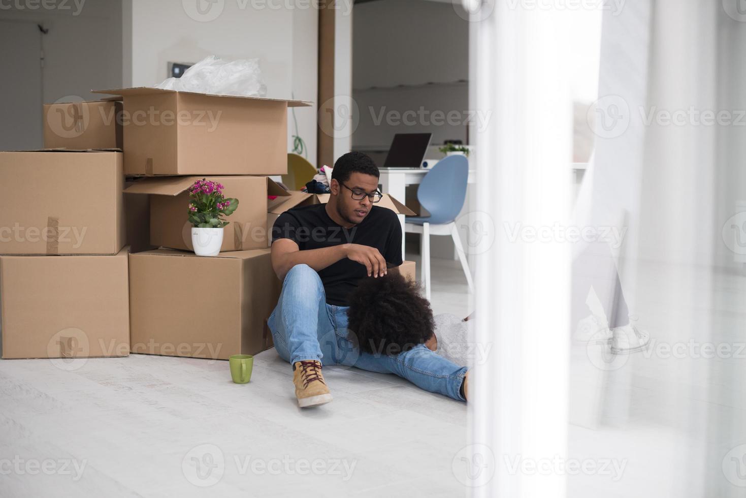 African American couple relaxing in new house photo