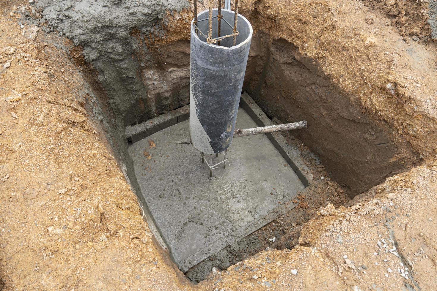 New preparing the foundation for construction columns with cement pole. Cement foundation with round cast columns with rebar for house pillars. photo