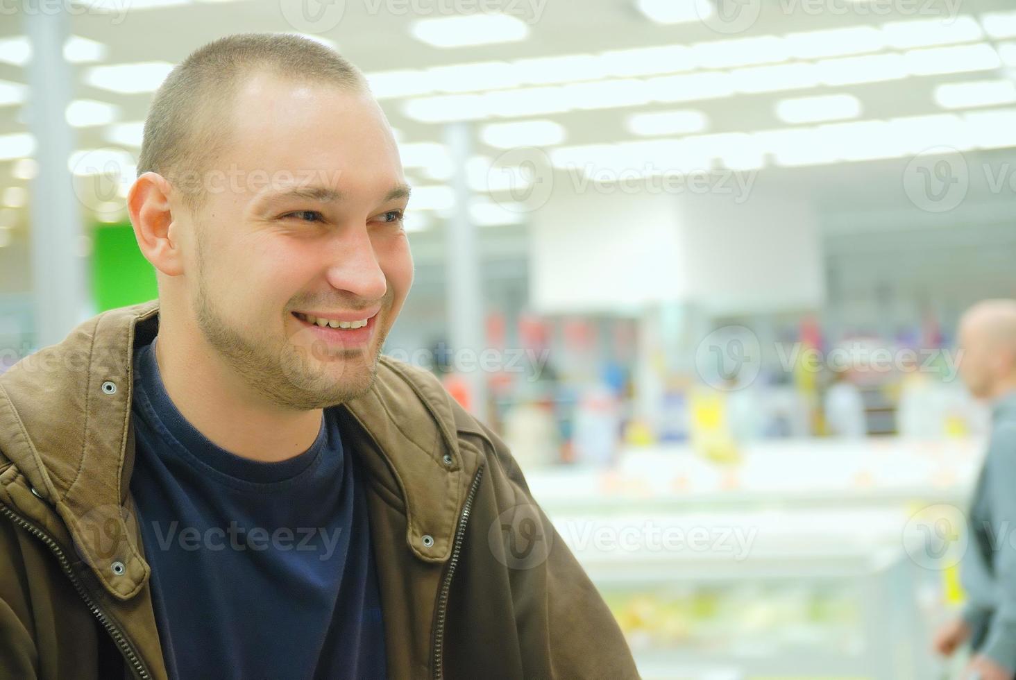 smiling man in supermarket photo