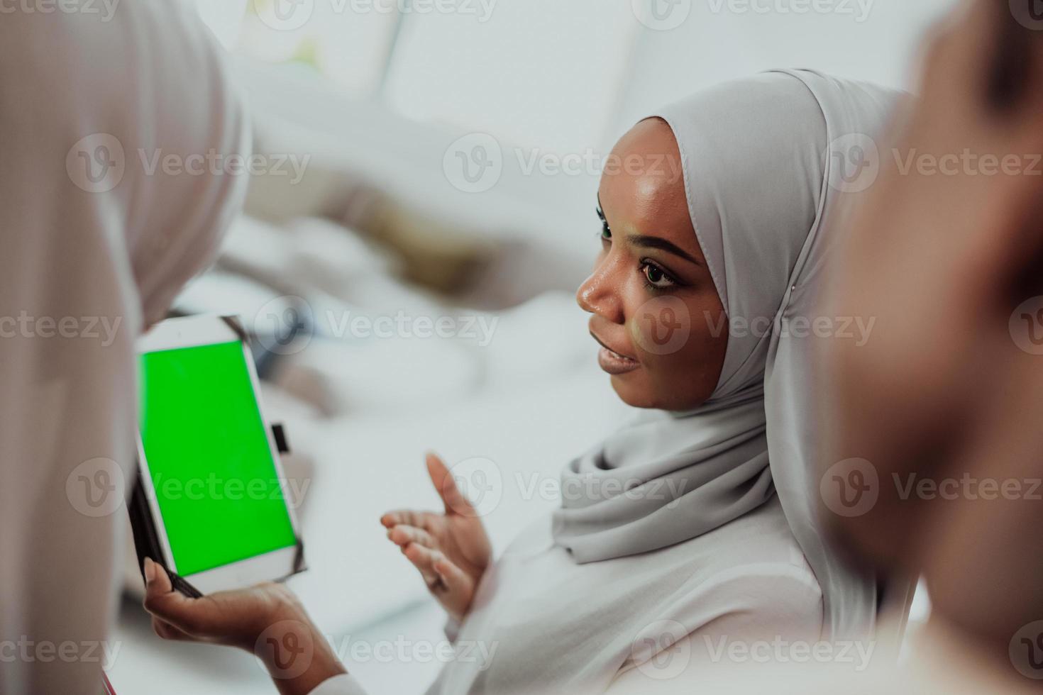 Group of happy african students having conversation and team meeting working together on homework girls wearing traidiional sudan muslim hijab fashion photo