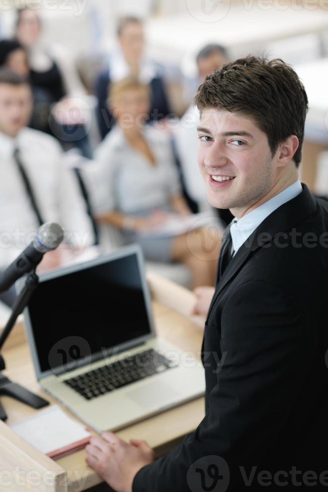 Young  business man giving a presentation on conference photo