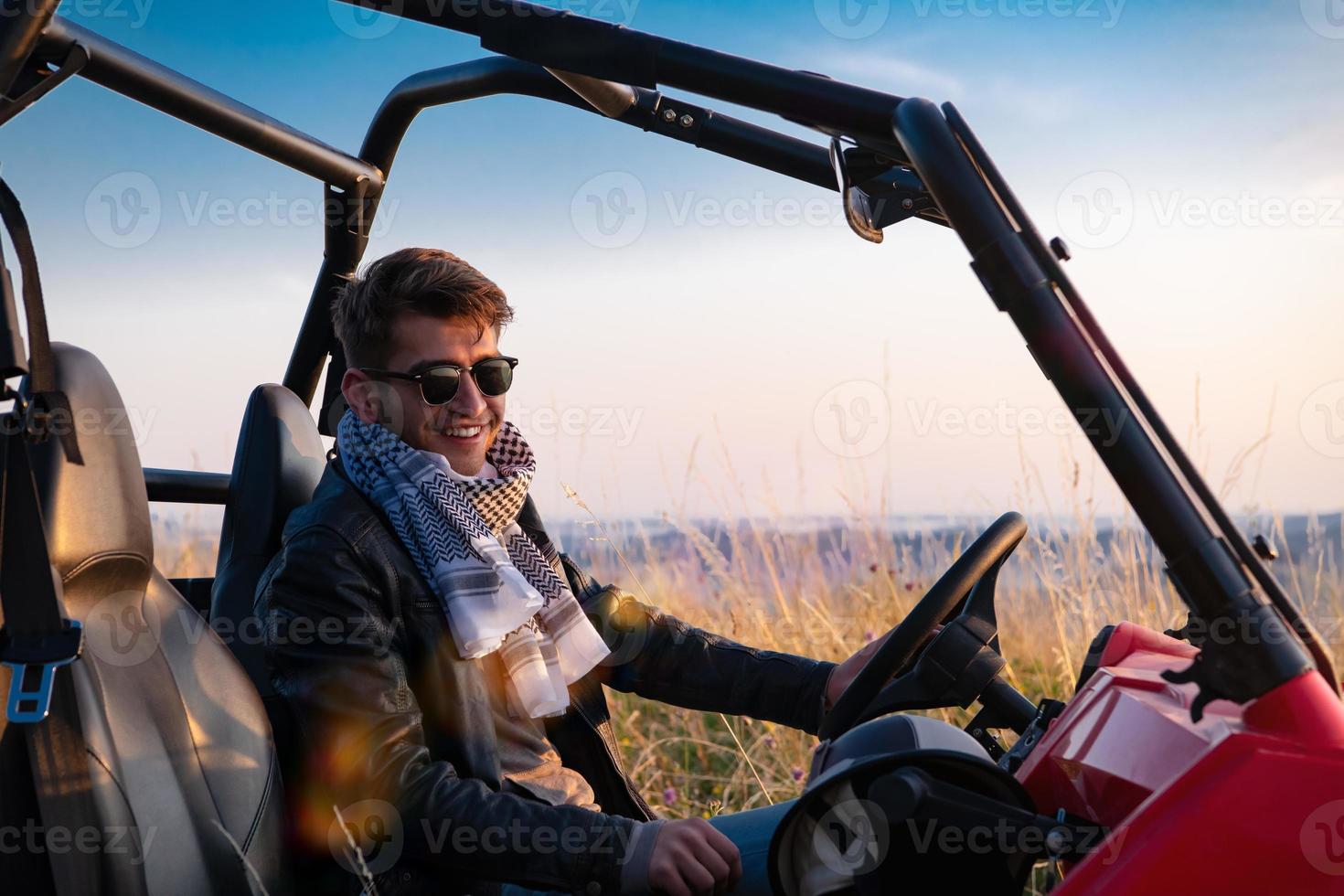 portrait of young man driving a off road buggy car photo
