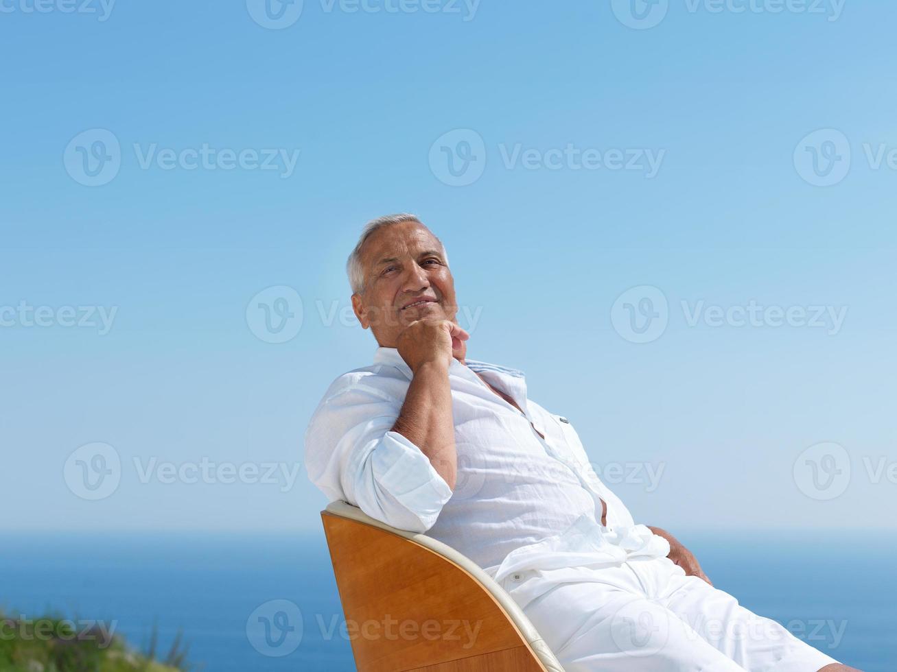 senior man sitting outside photo
