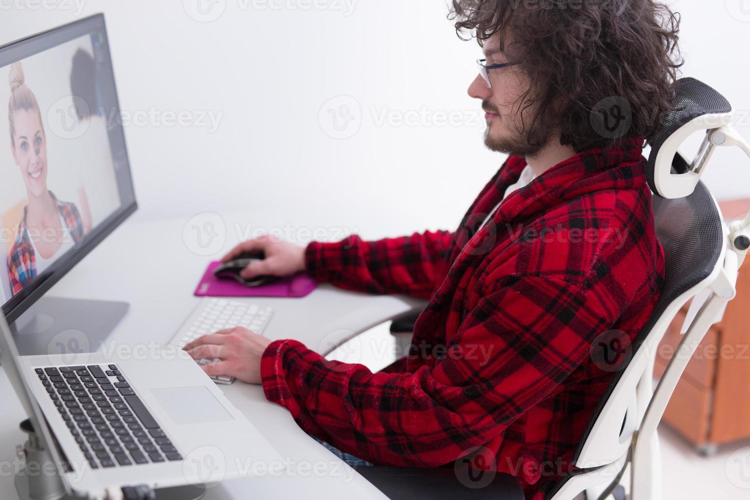 graphic designer in bathrobe working at home photo