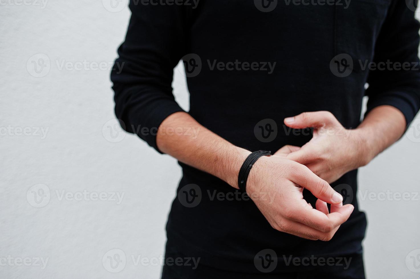 Hands of man in a fashionable black show bracelet beads. photo