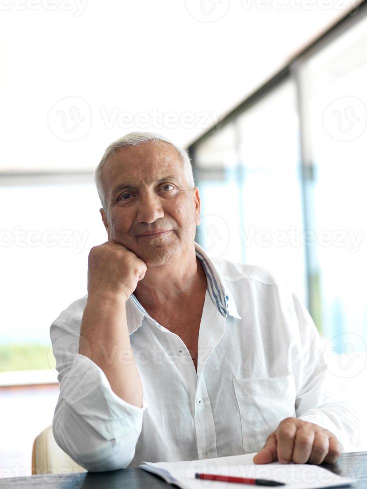 Portrait of senior man relaxing in sofa photo
