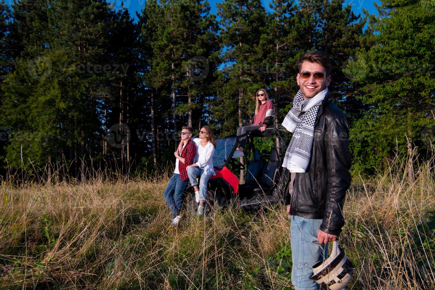 group of young people driving a off road buggy car photo