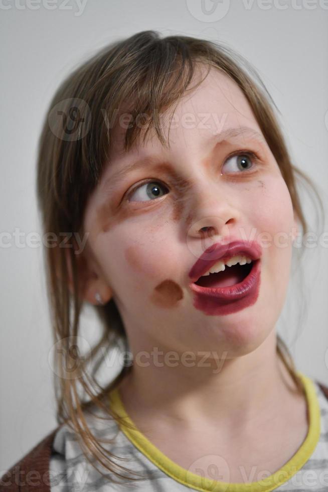 Little girl playing with mommy's make up photo
