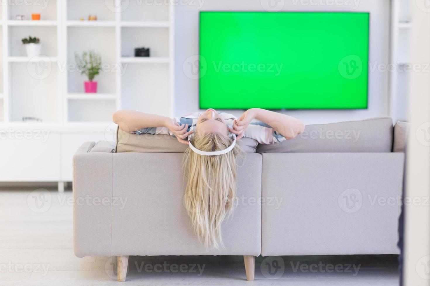 girl enjoying music through headphones photo