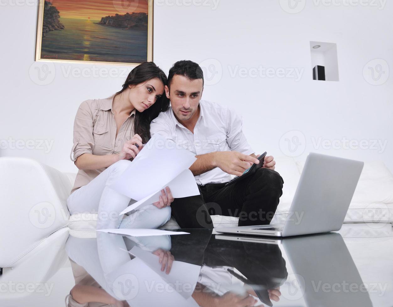 joyful couple relax and work on laptop computer at modern home photo