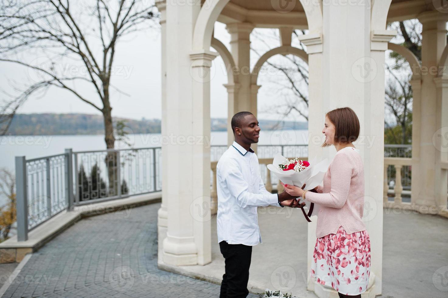 Happy multiethnic couple in love story. Relationships of african man and white european woman. photo