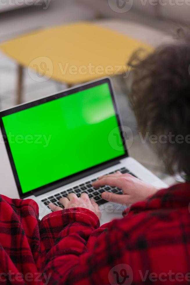 man freelancer in bathrobe working from home photo
