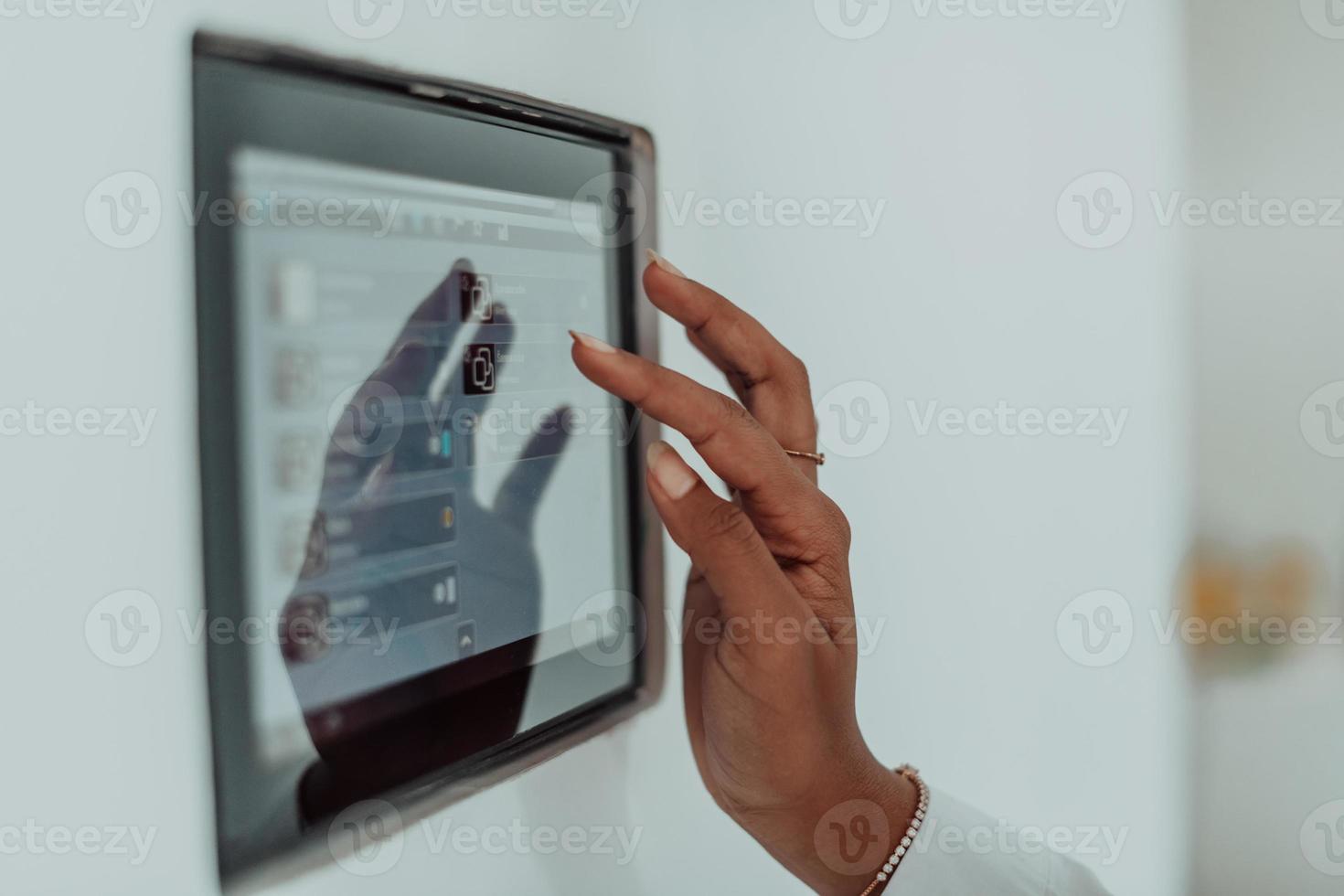 African woman using smart home screen control system photo