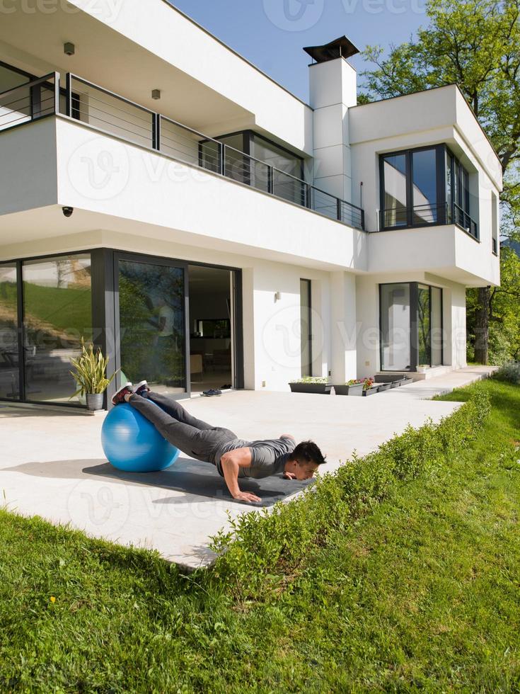 man doing morning yoga exercises photo