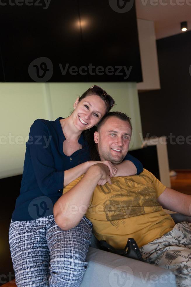 young handsome couple hugging on the sofa photo