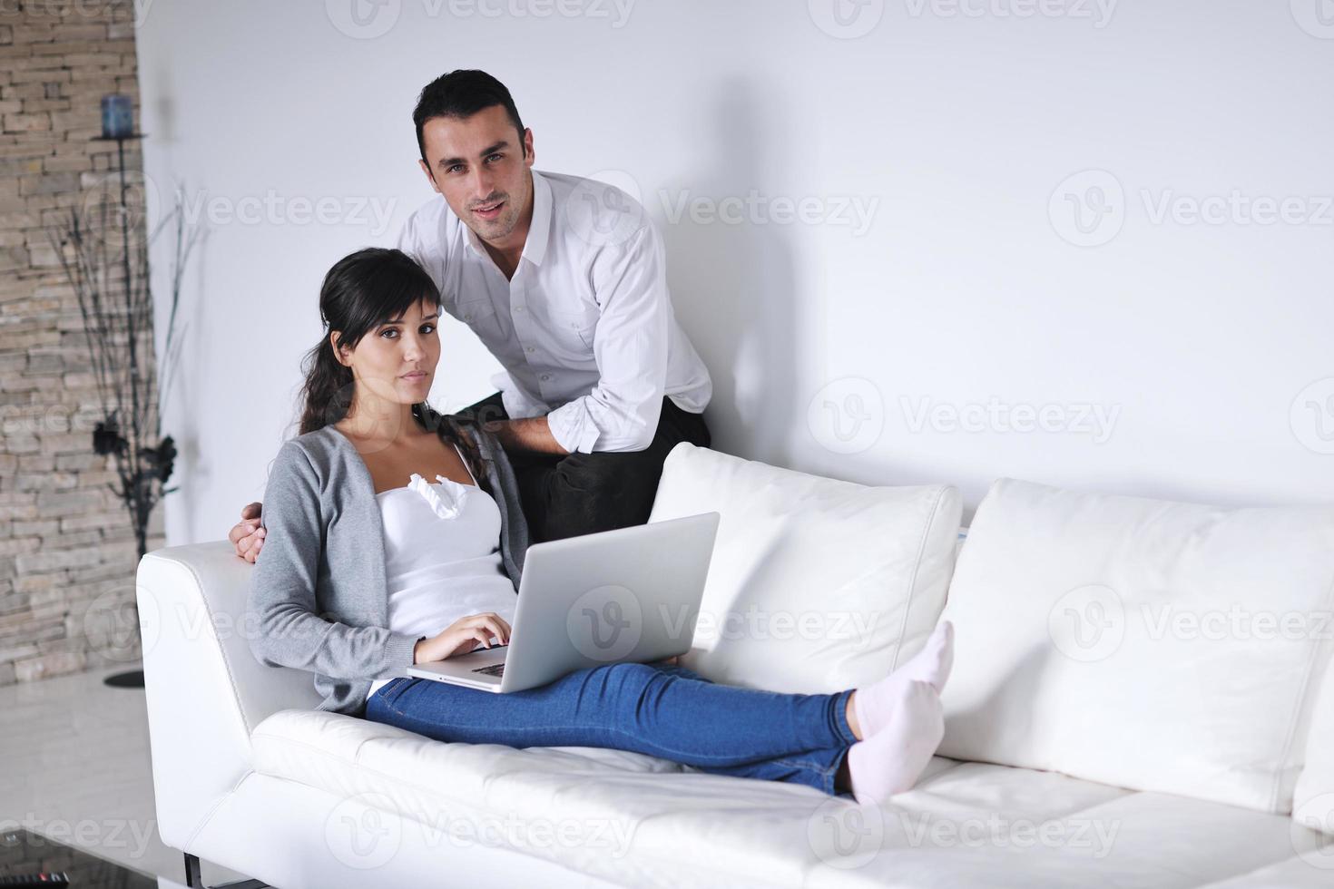 joyful couple relax and work on laptop computer at modern home photo
