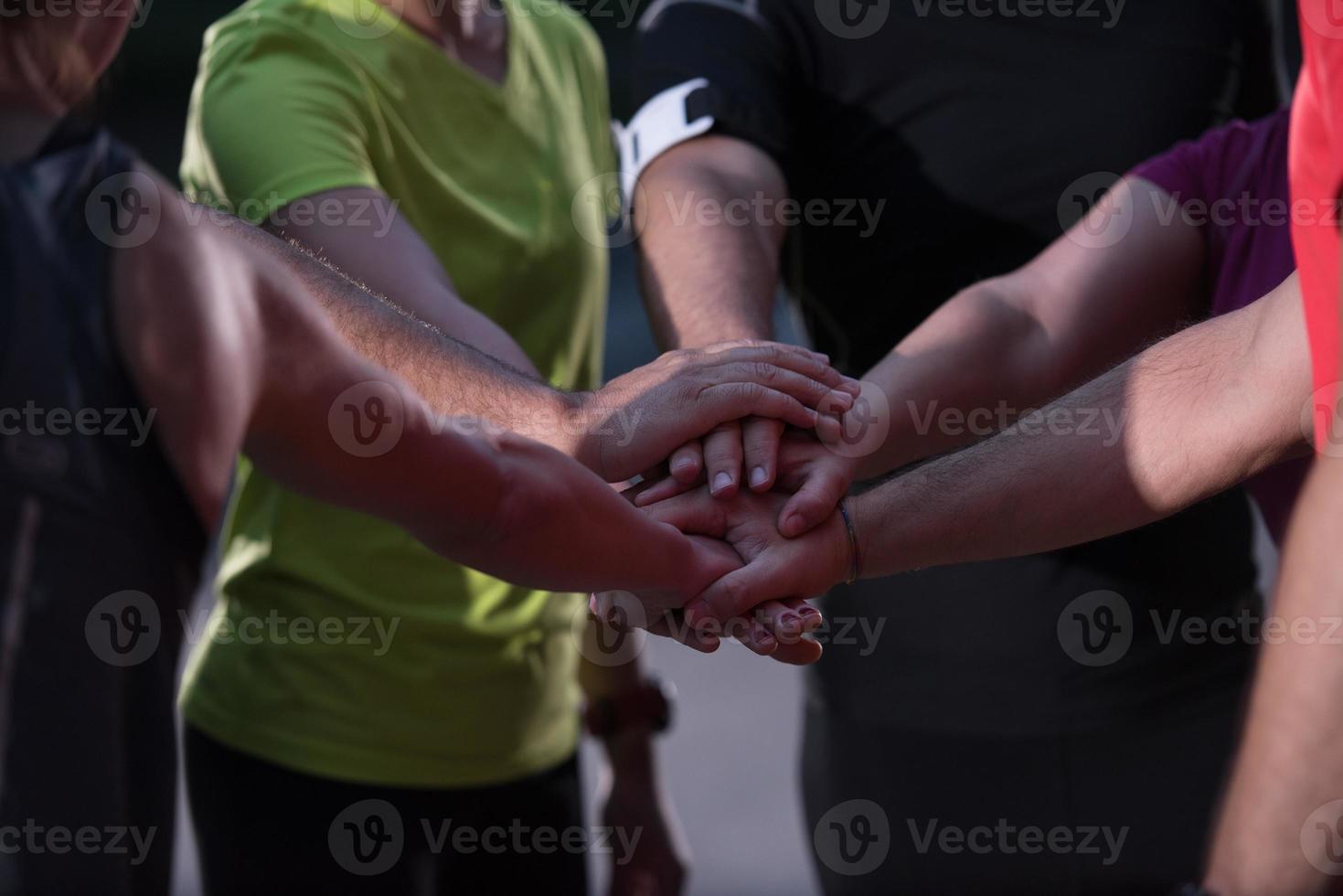 runners giving high five to each other photo