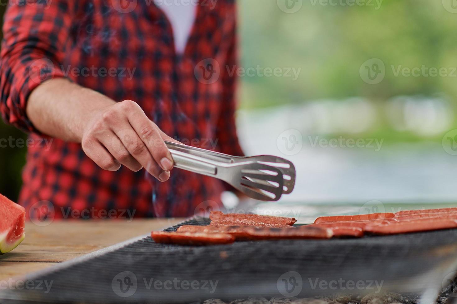 man cooking tasty food for french dinner party photo