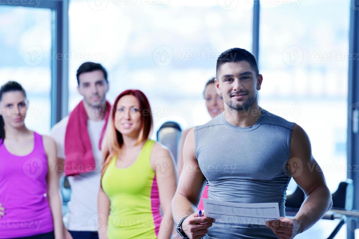 Group of people exercising at the gym photo