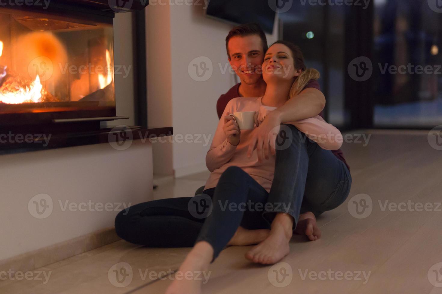 happy couple in front of fireplace photo