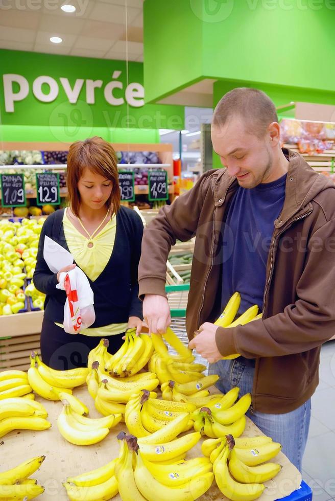 happy couple buying bananas photo