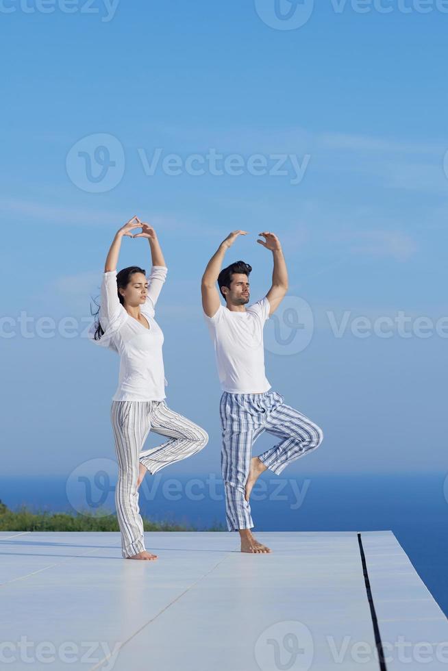 young couple practicing yoga photo