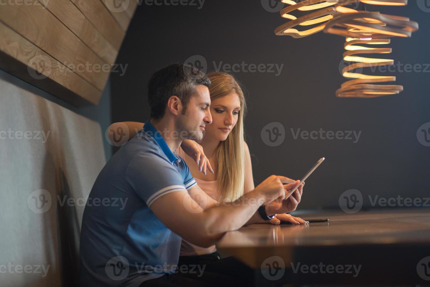 couple using tablet at home photo