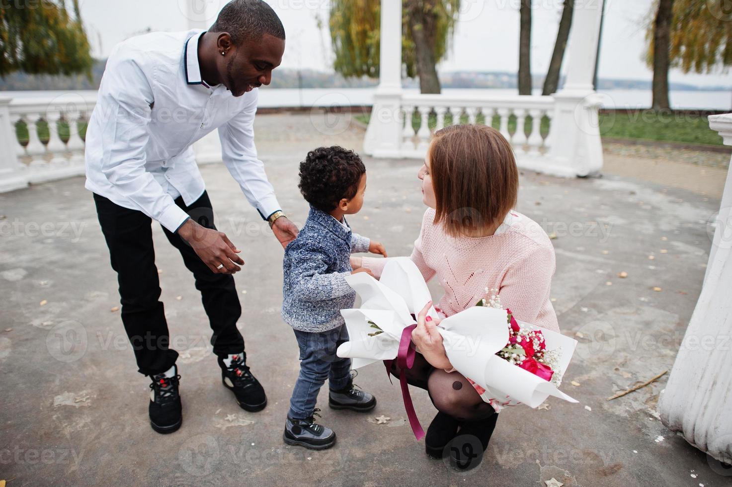 Happy multiethnic family with boy kid. Relationships of african man and white european woman. photo