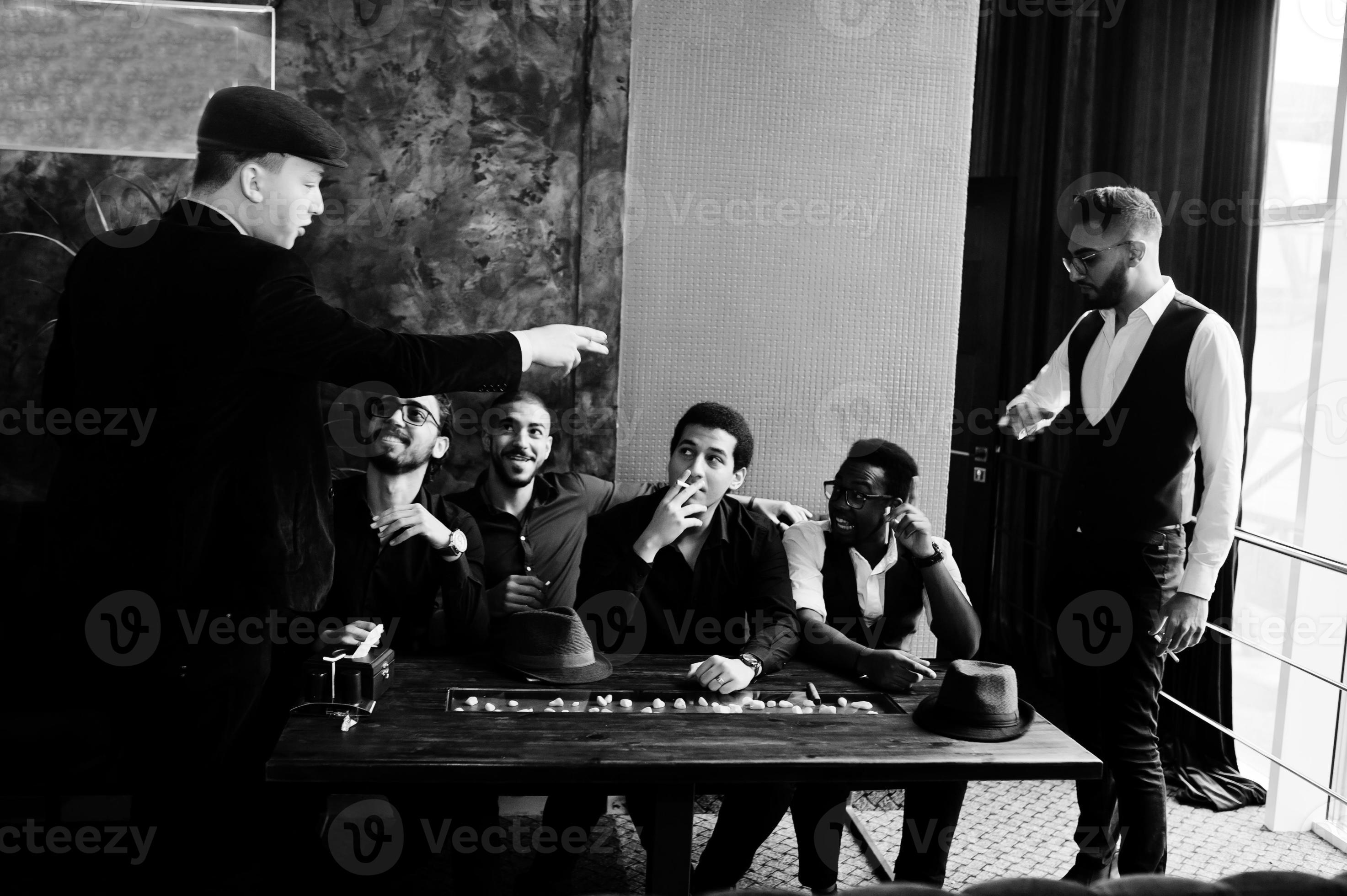 Group of handsome retro welldressed man gangsters spend time at club