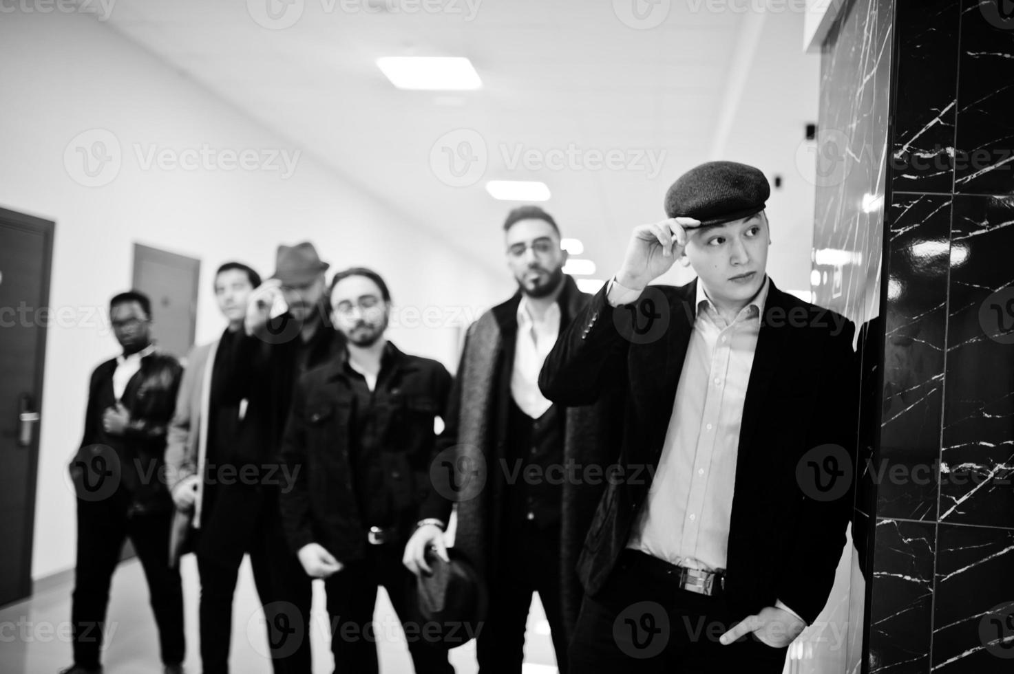 Group of handsome retro well-dressed man gangsters indoor at hotel. Multiethnic male bachelor mafia. photo