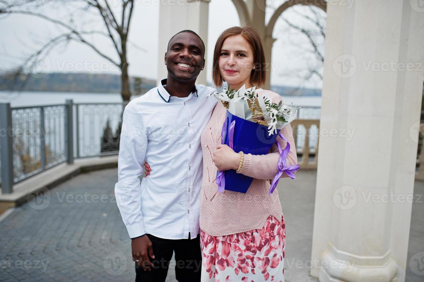 Happy multiethnic couple in love story. Relationships of african man and white european woman. photo