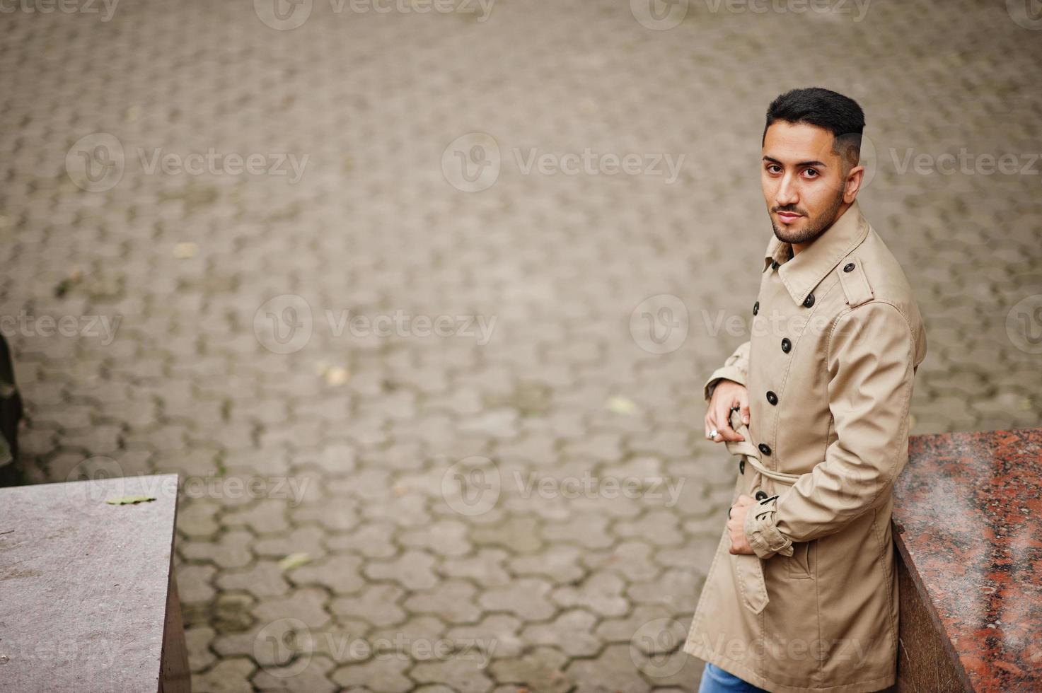 Stylish kuwaiti man at trench coat. photo