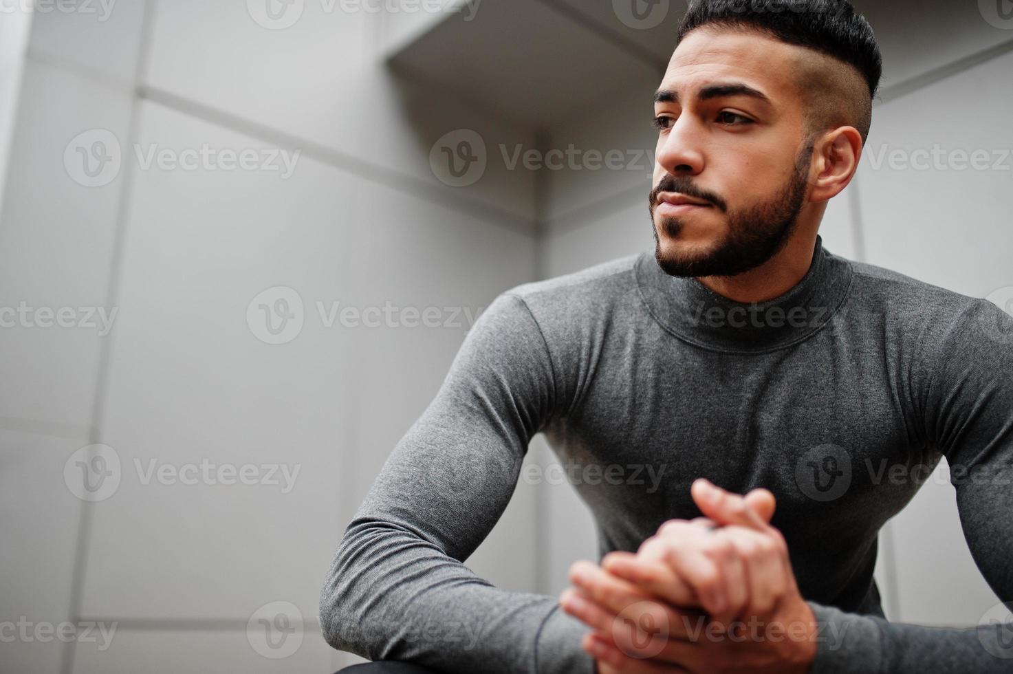Portrait of stylish arab beard man wear grey turtleneck. Arabian model guy against steel wall. photo