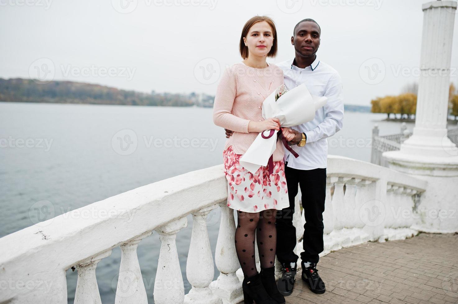 Happy multiethnic couple in love story. Relationships of african man and white european woman. photo