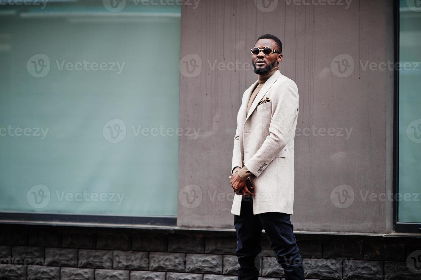 Stylish african american man wear beige jacket with sunglasses. photo