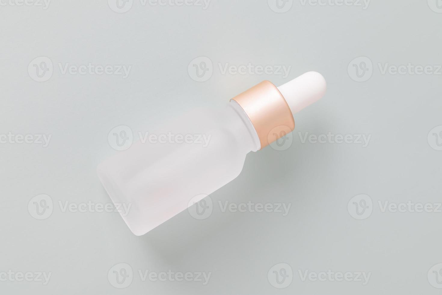 Natural skincare product in frosted glass bottle with dropper. Serum for woman facial skin. Herbal mineral cosmetic, vitamin body oil on blue background. Transparent package cosmetology with pipette. photo