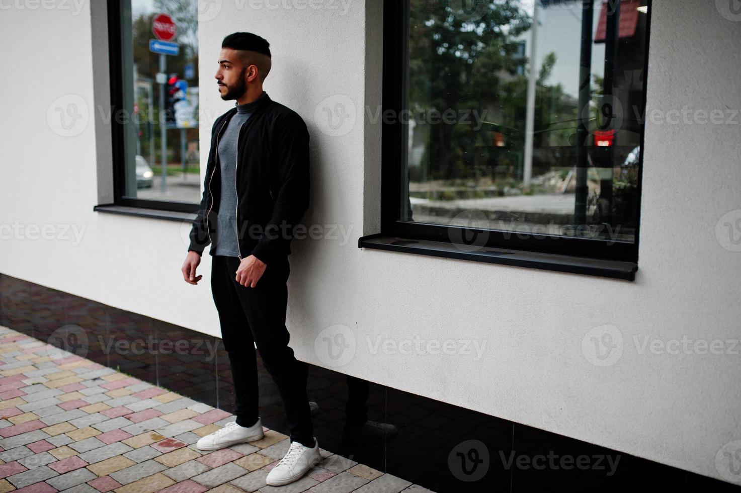 Portrait of stylish arab beard man wear grey turtleneck and black jaket. Arabian model guy. photo