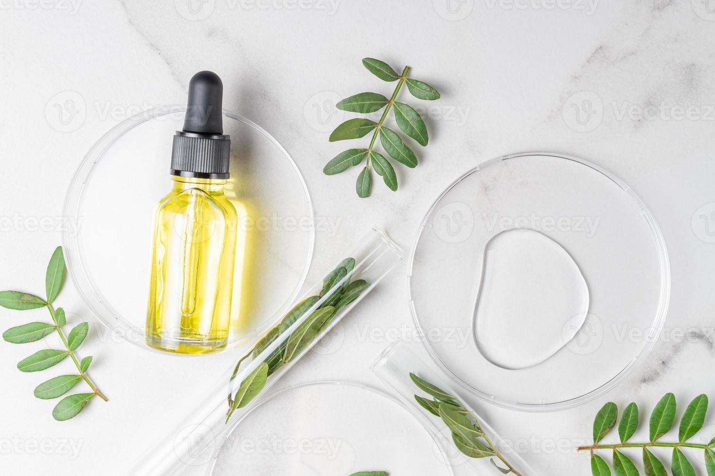 Serum with pipette in petri dish on white background. Top view, flat lay. Dermatology science cosmetic laboratory. Natural medicine, cosmetic research, organic skin care products. photo