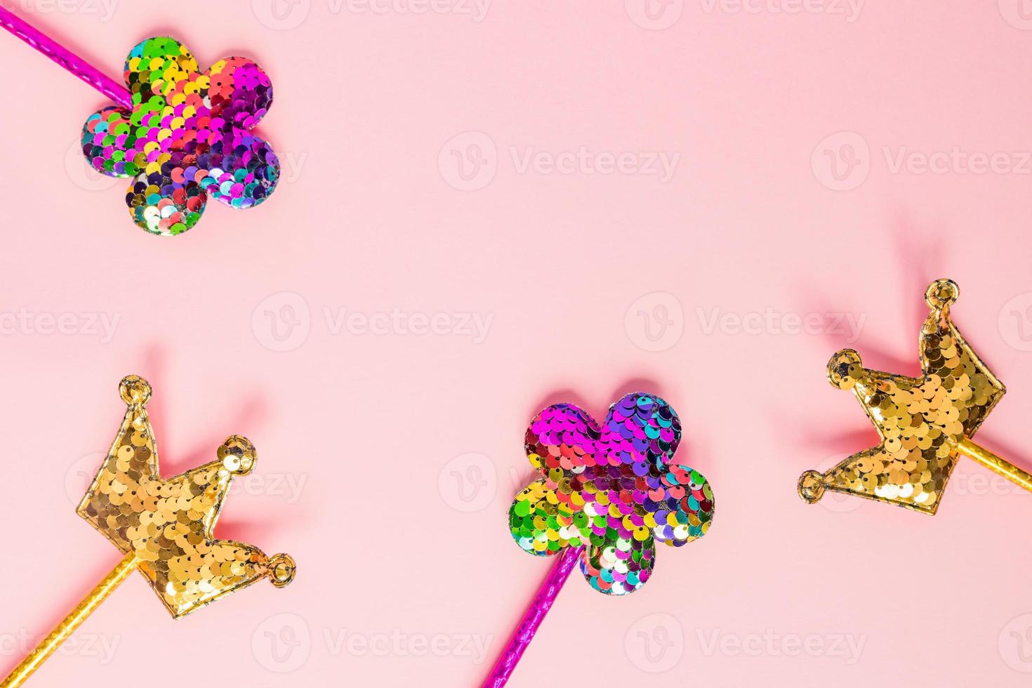 Golden crown and pink flower made of round sequins on pink background. Fashion party accessories with copy space. Festive flat lay. Minimal style. photo