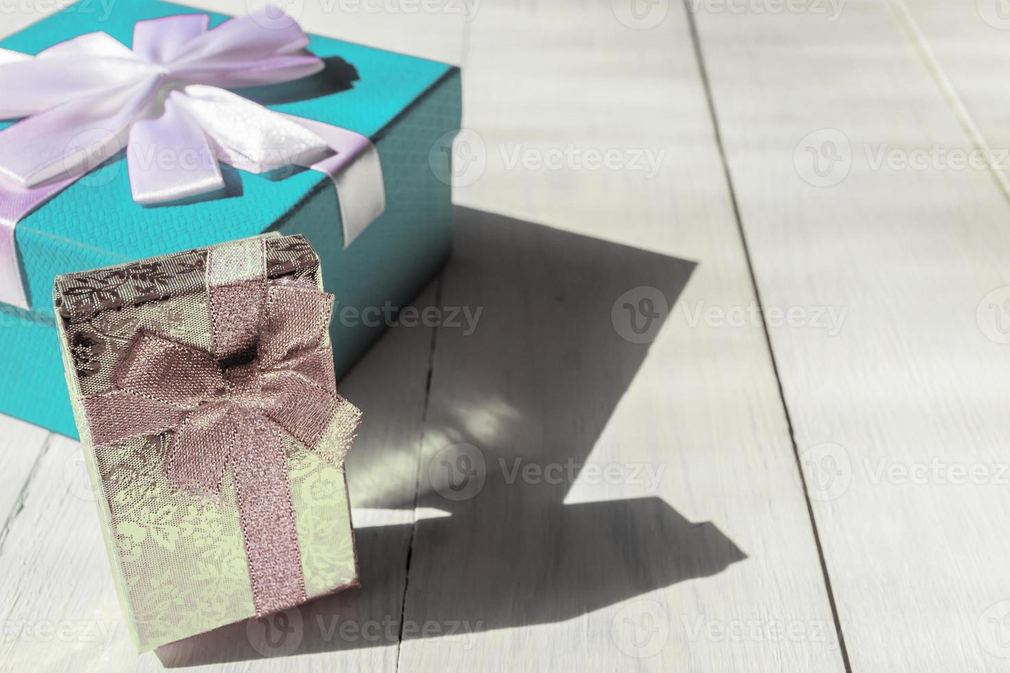 blue and silver gift boxes on wooden background. copy space for text. Festive greeting card for holidays. Birthday presents photo