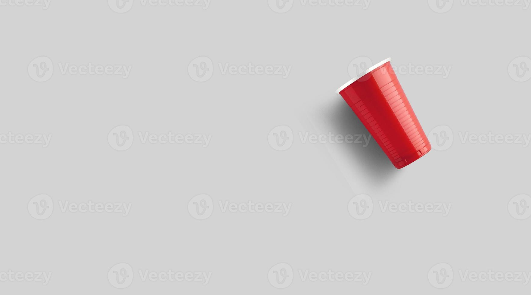 Red plastic cup isolated on grey. Beer pong game concept photo