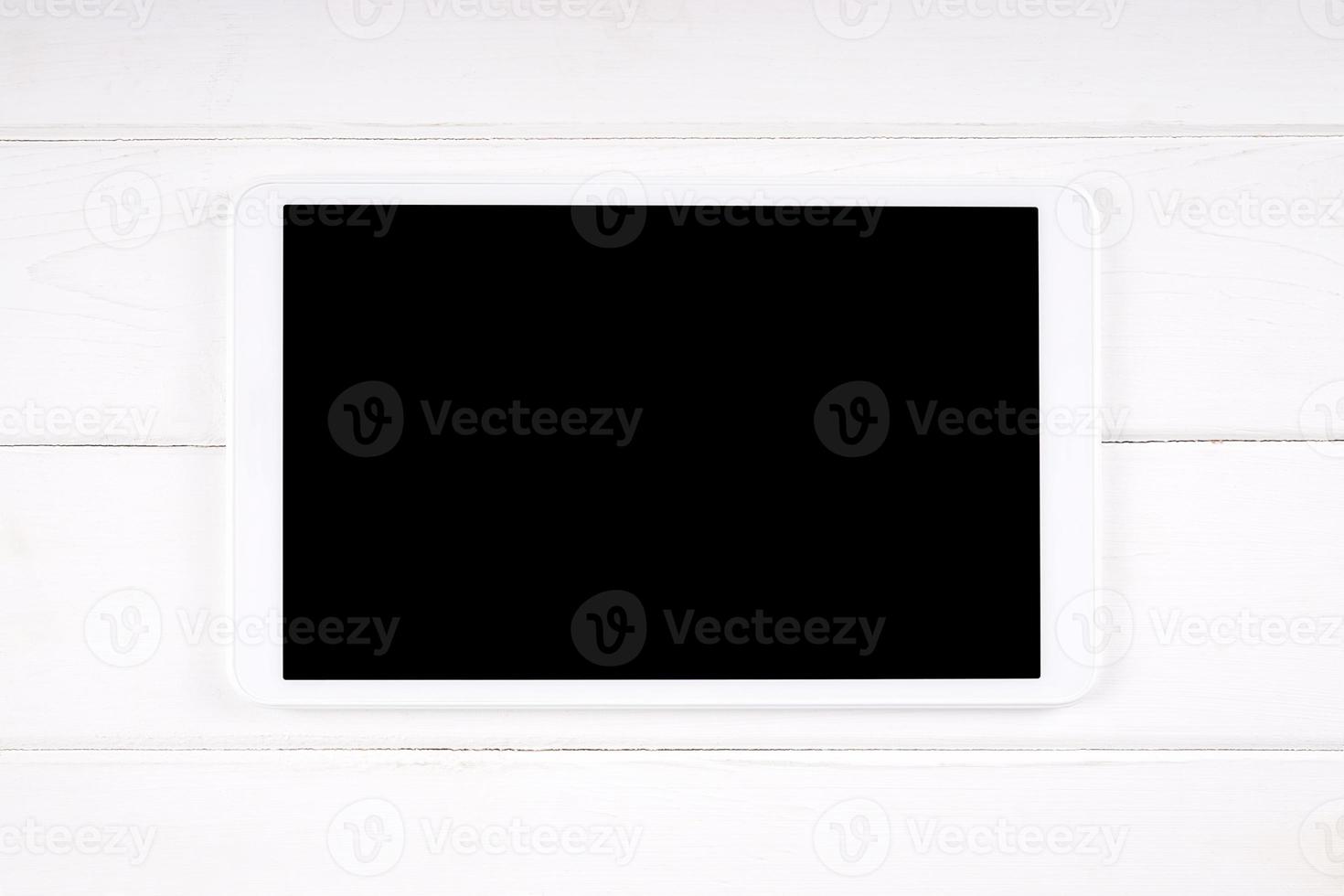 tablet computer with empty display on white wood photo